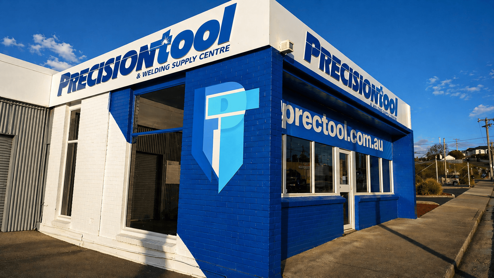 Precision Tool & Welding Supply Centre storefront in Devonport, blue and white building corner with signage